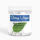 A close-up of Being Vegan Bee Bread Powder bottle with sachets inside, containing a blend of bee bread, royal jelly, and propolis, perfect for boosting immune function and overall health.